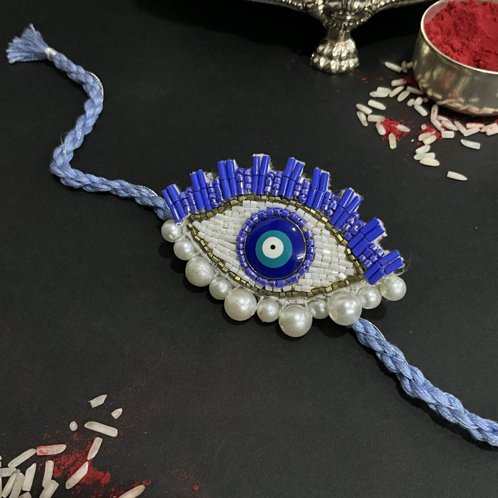 CHARM AGAINST EVIL (BLUE EVIL EYE RAKHI + BROOCH)